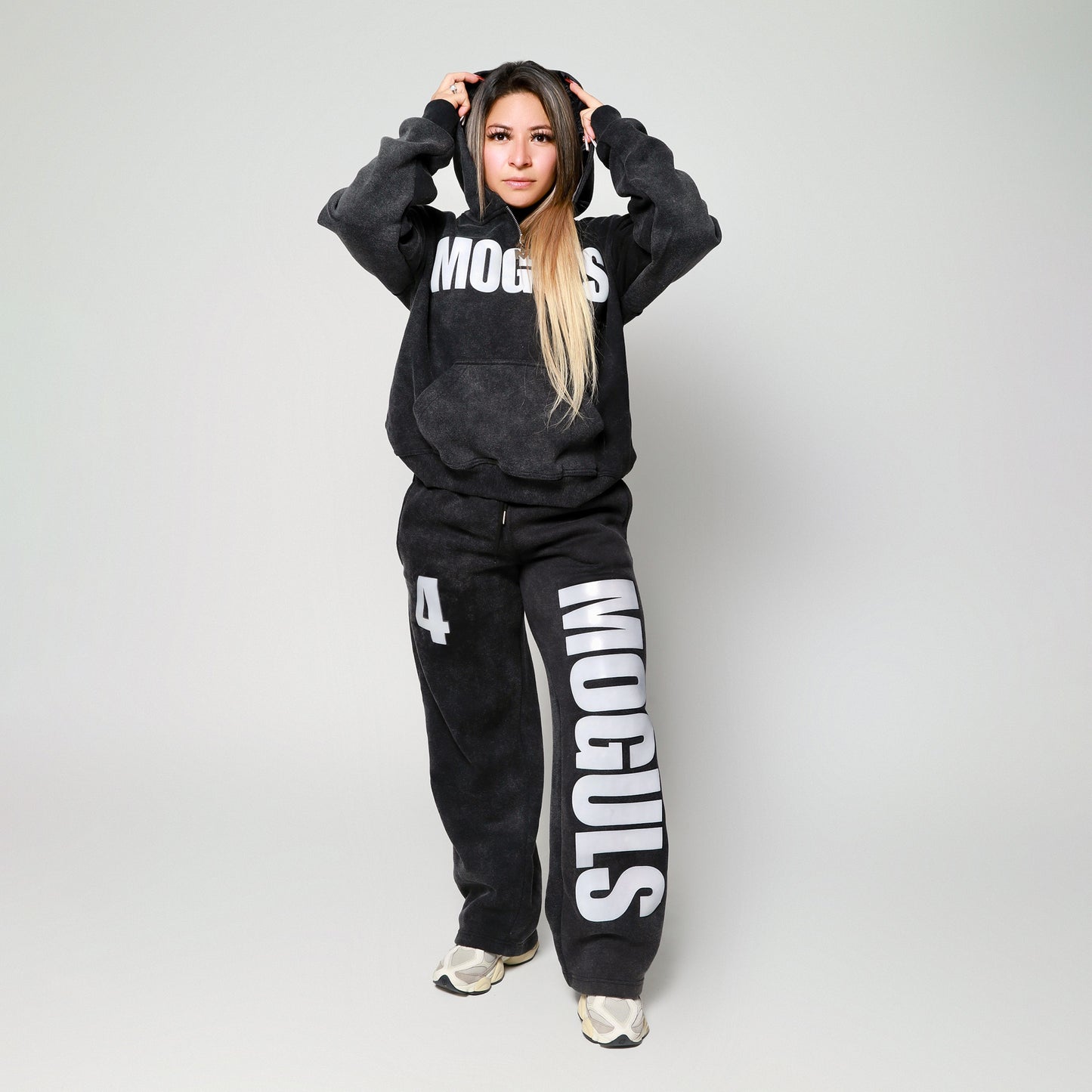 Woman wearing the 4 Moguls Oversized Sweatsuit in black styled said size XS for a relaxed oversized fit