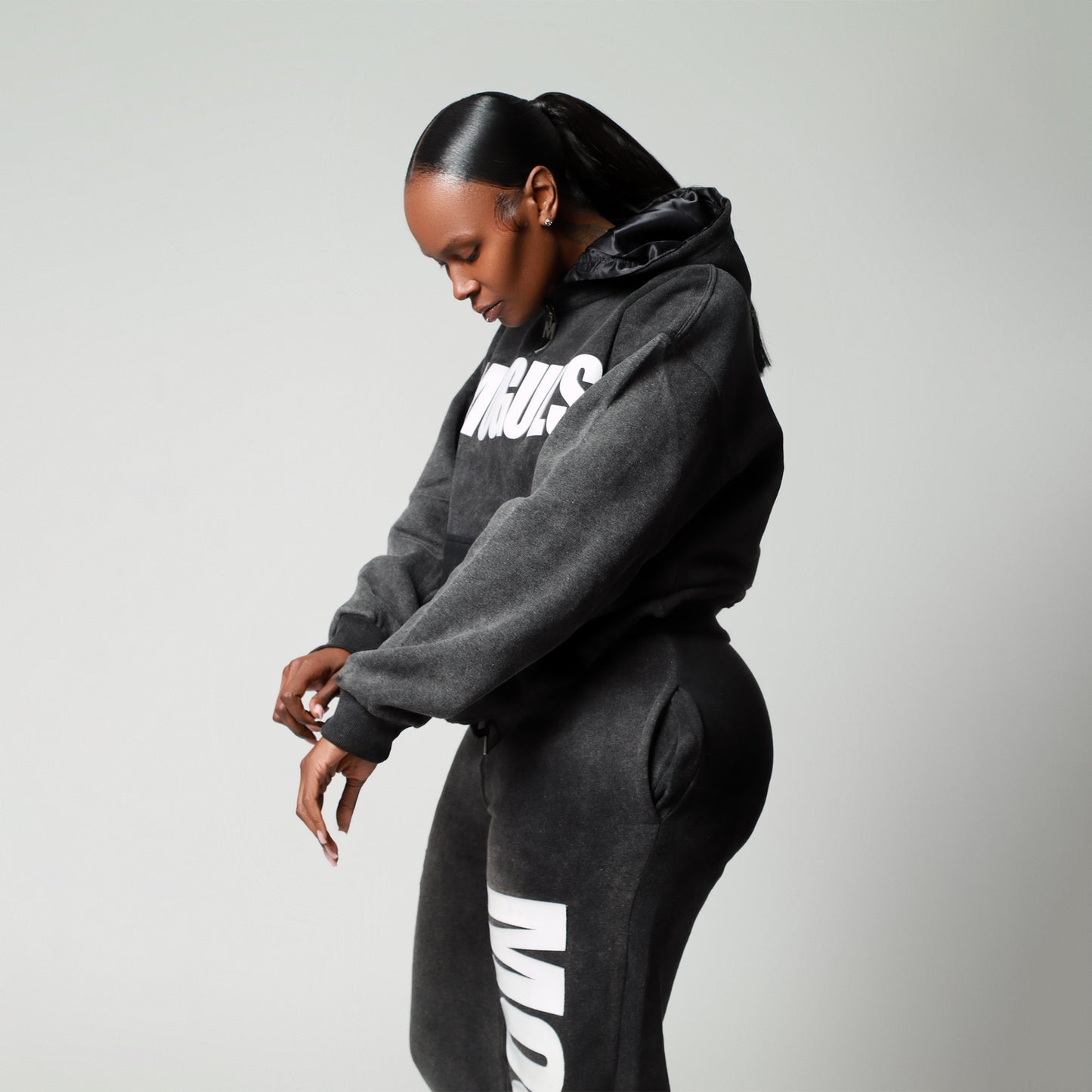 Side view of woman wearing 4 Moguls Oversized Sweatsuit highlighting oversized hoodie fit and sweatpants