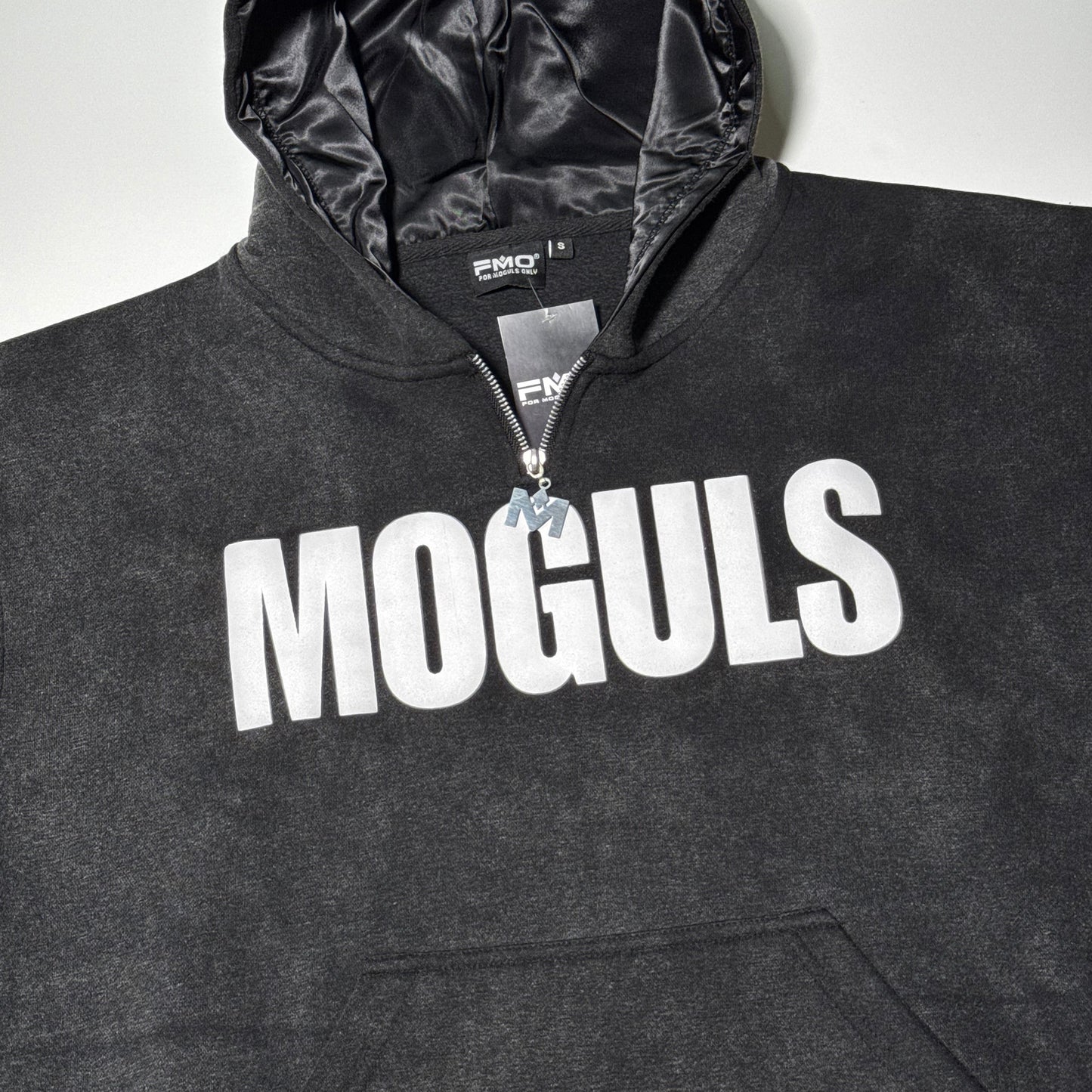 Flat lay of black 4 Moguls Oversized Sweatsuit hoodie with bold MOGULS logo