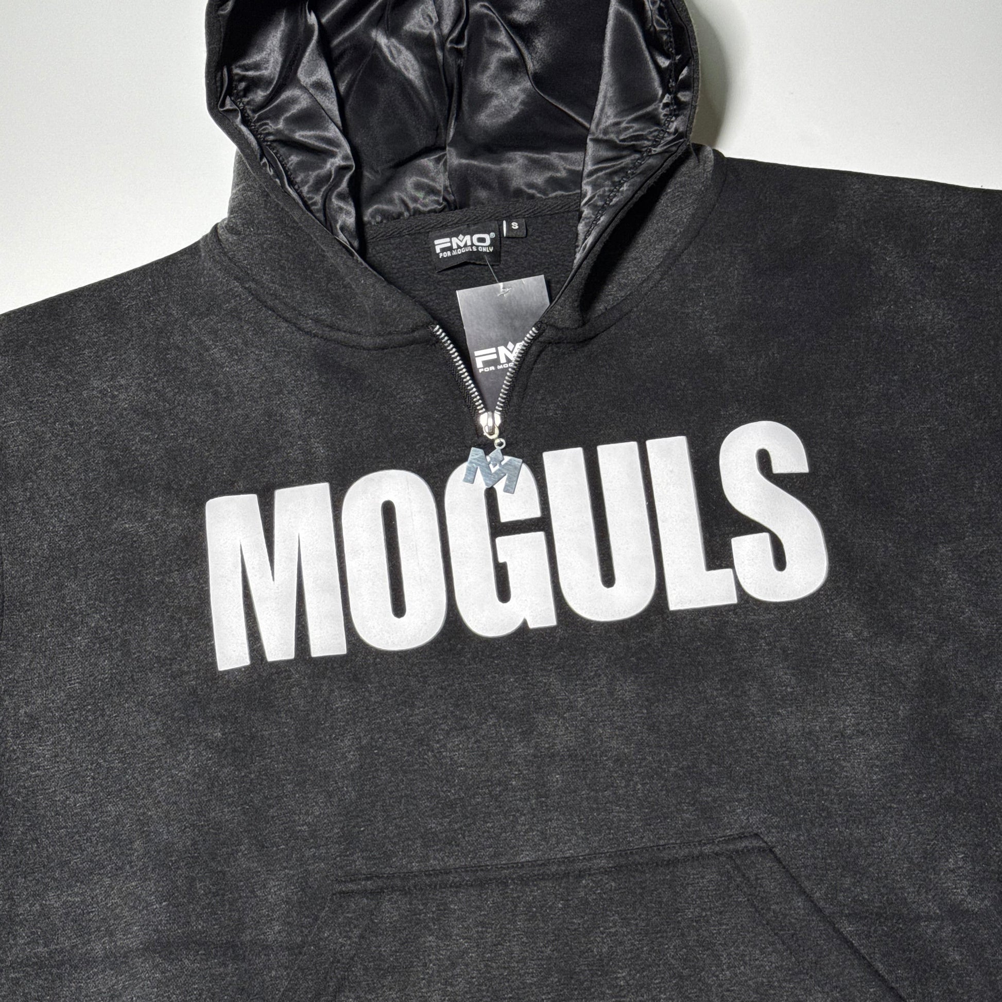 Flat lay of black 4 Moguls Oversized Sweatsuit hoodie with bold MOGULS logo