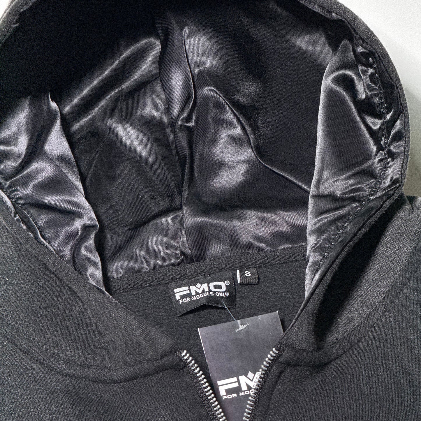 Interior view of 4 Moguls Oversized Sweatsuit hoodie showing satin-lined hood and premium finish