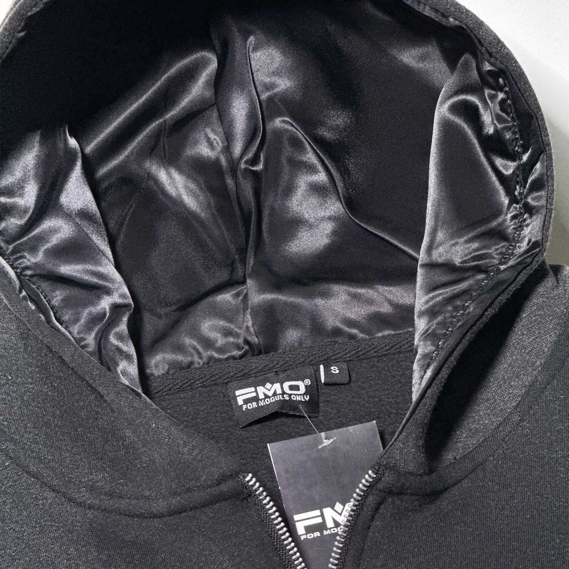 Interior view of 4 Moguls Oversized Sweatsuit hoodie showing satin-lined hood and premium finish