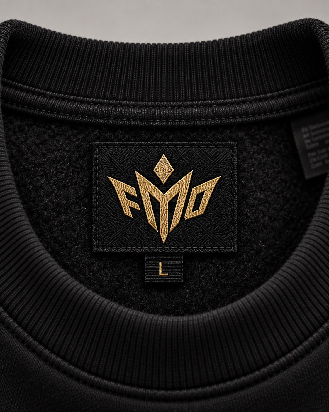 Custom black and gold FMO woven neck label inside anniversary crewneck