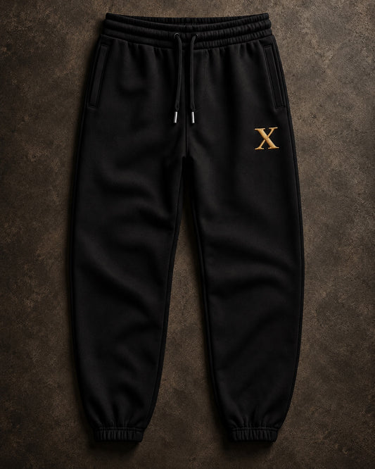 FMO X Anniversary Jogger front view in black with gold Anniversary X and metal-tipped drawcords.