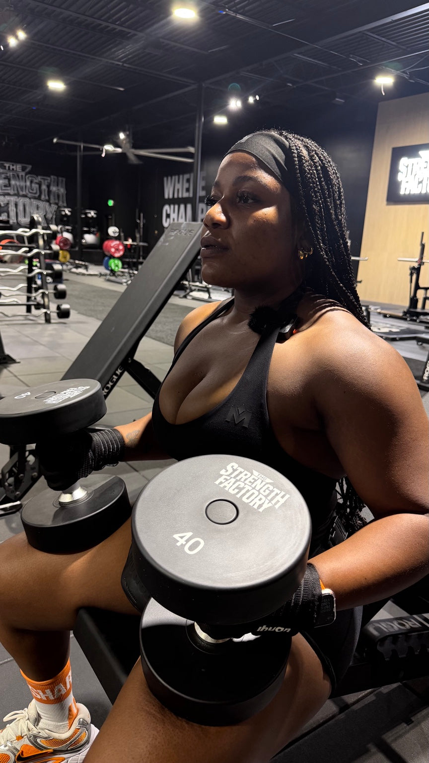 Woman training with dumbbells in the black Quiet Bra
