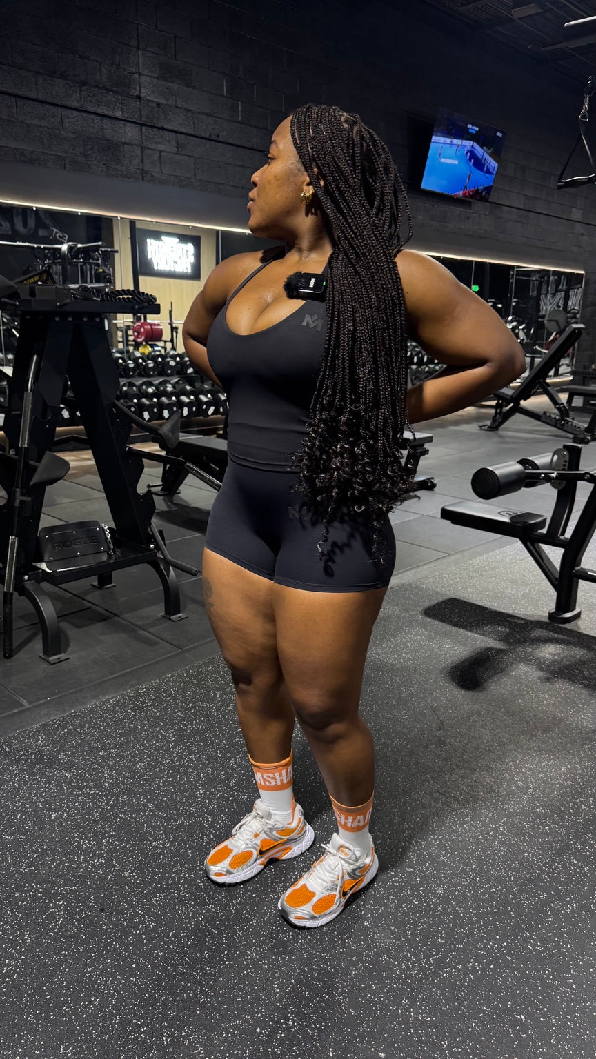 Side profile of the black Quiet Bra and Pressure Short workout set